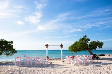 Empty chairs and alter at wedding on the beach