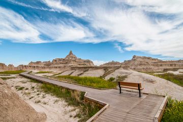 A bench to rest and enjoy the beauty on a boardwalk trail in Badlands National Park.