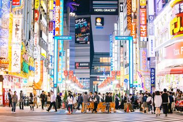 Bright neon lights in and crowded streets in Shinjuku, Tokyo, Japan