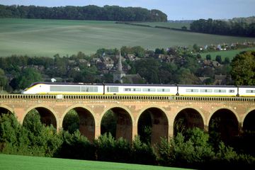 A high speed Eurostar trainset is captured crossing the Ouse Valley en route to London's Waterloo terminus.