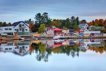 Greenville, Maine, USA - October 3, 2019: Daytime view of the downtown district reflecting on Moosehead Lake during the autumn season
