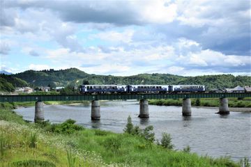 Exterior view of train going over water via bridge