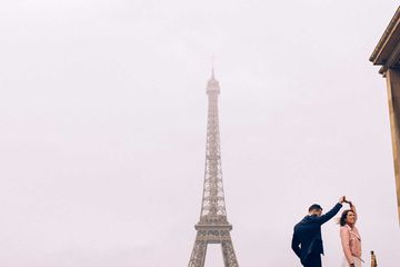 Couple dancing in front of the Eiffel Tower in Paris, France