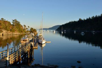 Boats tied up at dock in Fossil Bay, Sucia Island, San Juan Islands, Washington State