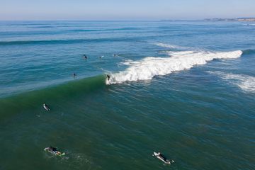 Surfers making the most of the last day of Summer with a surf at a local Mornington Peninsula beach located in Victoria Australia as captured from above.