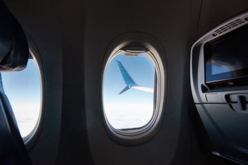 View of an airplane wing through an airplane window