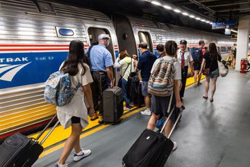 People boarding an Amtrak training in a station 