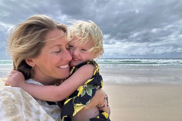 Kathryn Romeyn and her first born share a moment on the beach