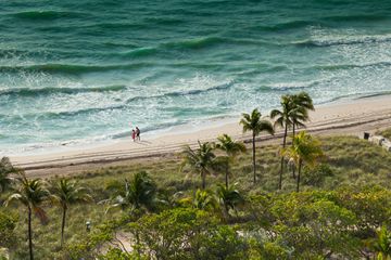 Couple walking on the beach, Bal Harbour, Florida