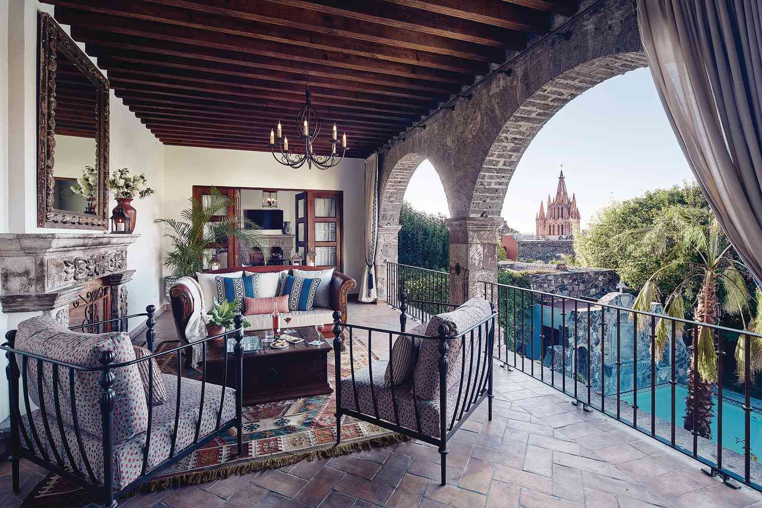Terrace seating with city view at Casa de Sierra Nevada, a Belmond Hotel