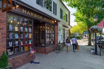 Mother and daughter pass a bookstore in Downtown Sag Harbor