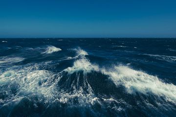 Boat wake waves in the Drake Passage, causing spray to come off the water.