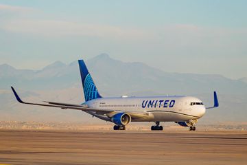 A United Plane with mountains behind it