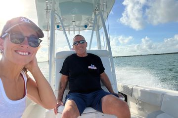 Nina Ruggiero and father smile on a boat during a fishing excursion 