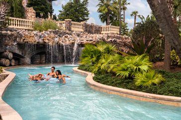 Family in a lazy river at Four Seasons Resort Orlando