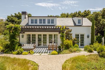 Gwyneth Paltrow's guesthouse exterior with covered patio in a garden 