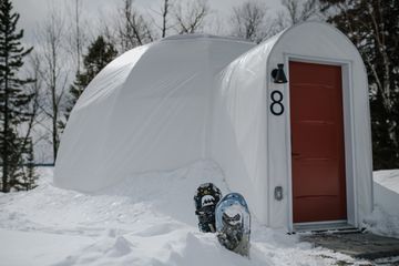 Exterior of a dome with snowshoes out front at Station Boreale in Canada 