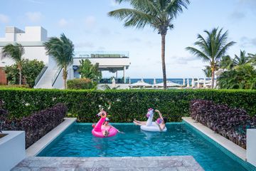 Two girls in a pool with floats at Excellence Oyster Bay, Jamaica 