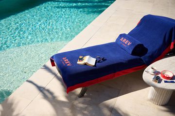 A lounge chair around the pool at AREV St Tropez Hotel 