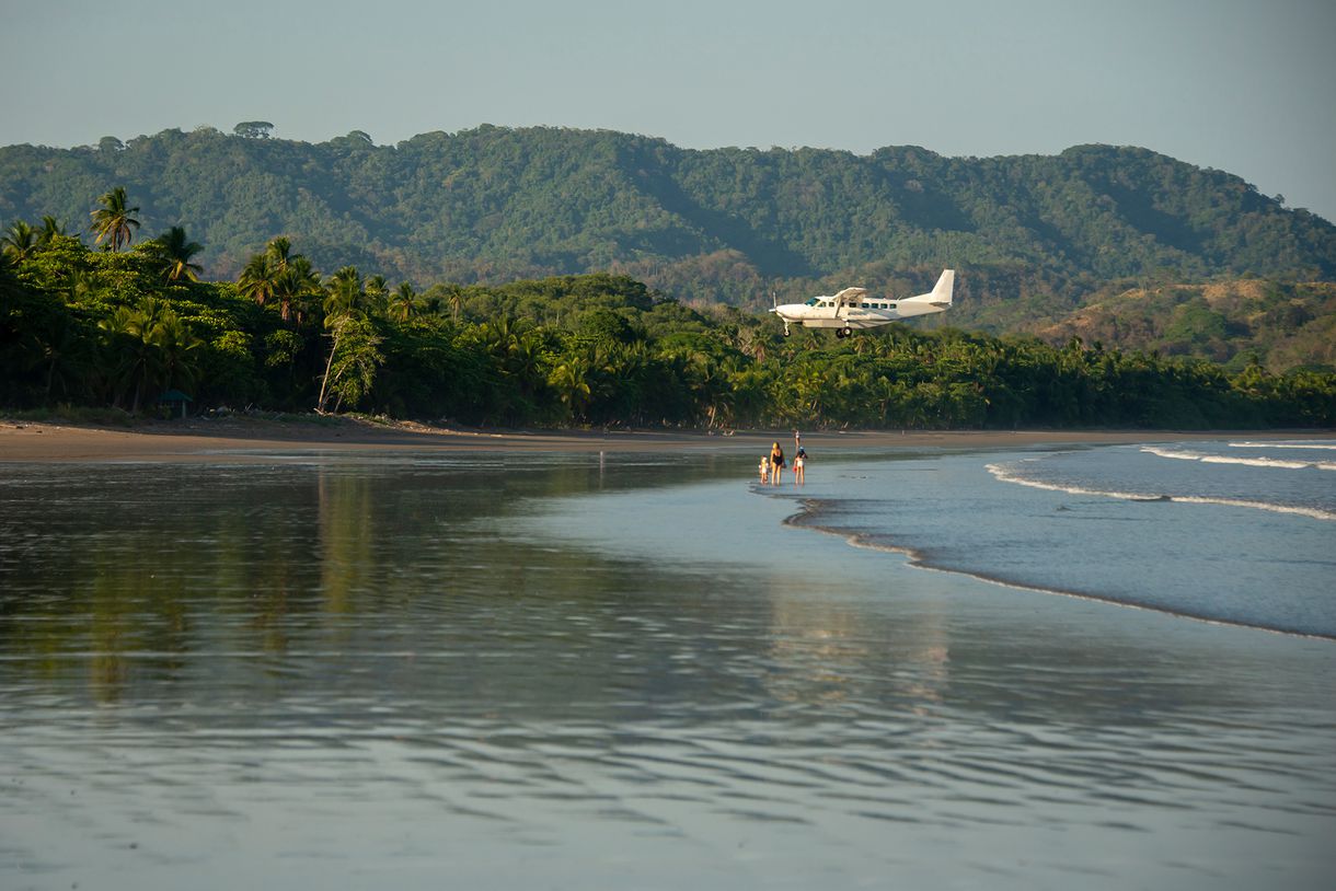 Plane landing near Tambor Beach, Nicoya Peninsula, Montezuma, Costa Rica