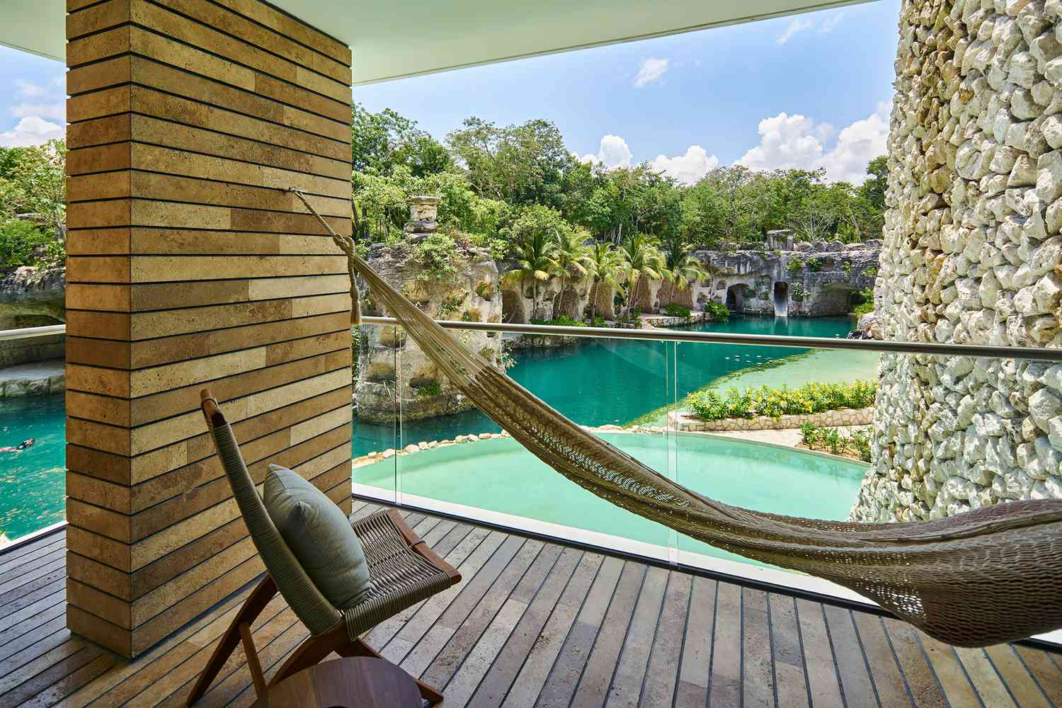 Outdoor lounge seating with view of water at Hotel Xcaret Arte
