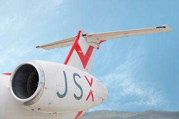 JSX jet exterior with blue skies 