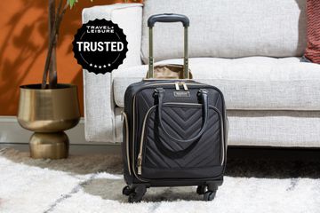 A Kenneth Cole Reaction Chelsea Expandable Underseat Luggage in a living room