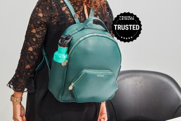 Person wearing a blue Bee & Kin The Midi Nomad Backpack