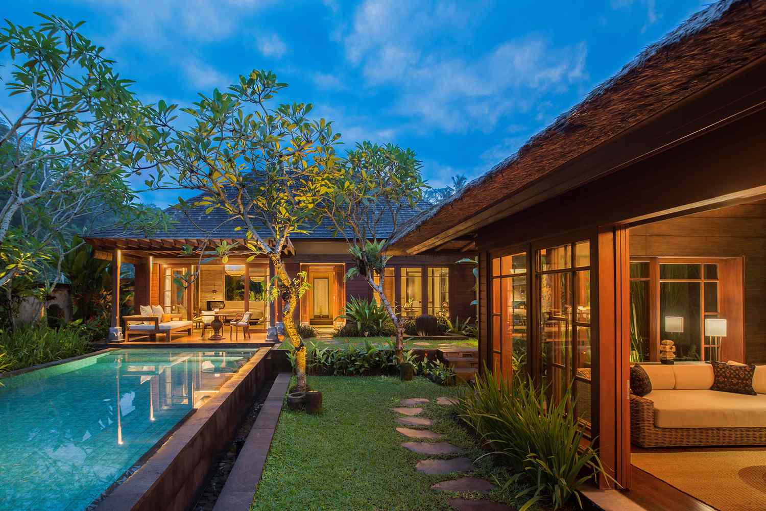 Suite with outdoor pool at twilight at Mandapa, a Ritz-Carlton Reserve