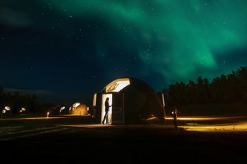 A guest dome at Métis Crossing, under the northern lights