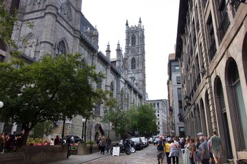 Groups of people walking past Notre Dame in Montreal 
