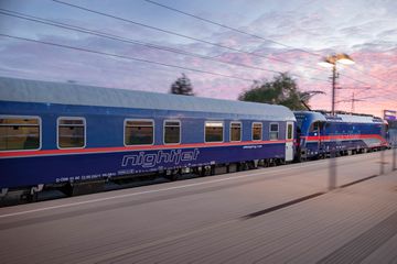 The exterior of a Nightjet train during sunset