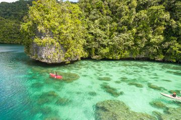 Two kayakers exploring Palau waters and islands