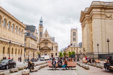 People in a square surrounded by beautiful architecture in Paris