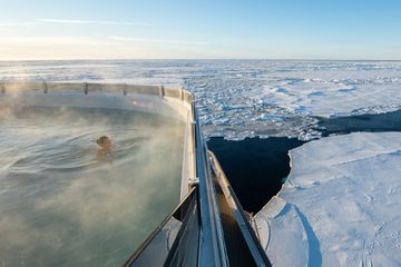 A woman in a jacuzzi in the arctic