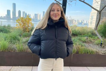 A person wearing the Canada Goose Garnet Cropped Puffer Jacke
