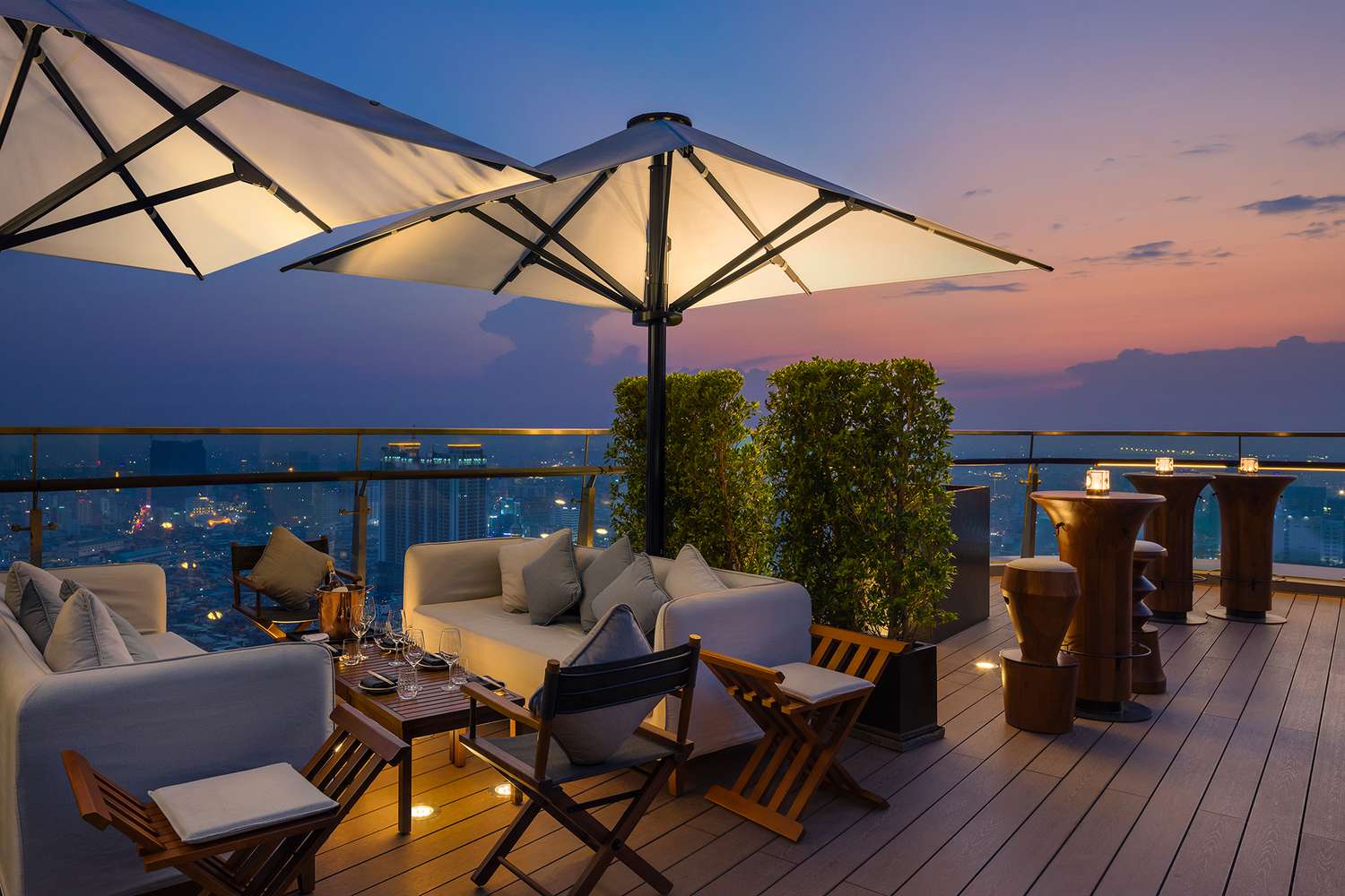 Outdoor rooftop lounge at sunset at Rosewood Phnom Penh