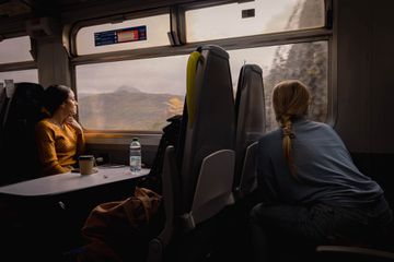 Train passengers peer out of window in Scotland