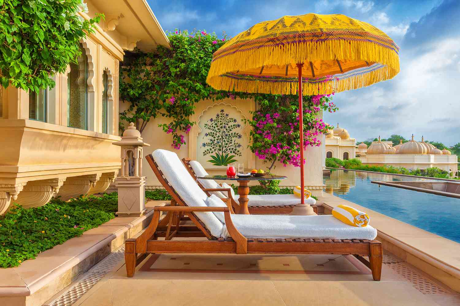 Lounge seating next to pool at The Oberoi Udaivilas, Udaipur