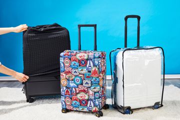 Picture of three suitcases with luggage covers on them