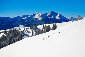 Skiers going down Vail Mountain 