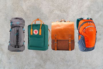 assortment of backpacks for travelers we recommended on smokey background