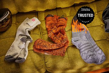 Three pairs of heated socks we recommend displayed on a couch