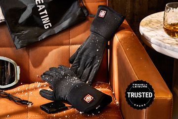 SunWill Heated Glove Liners on a brown leather couch