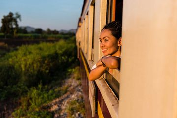 Smiling Woman Looking Through Train Window